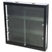 Schwarze Wandvitrine Duo mit LED-Beleuchtung, zwei Glasablagen und abschließbaren Schiebetüren in perspektivischer Ansicht